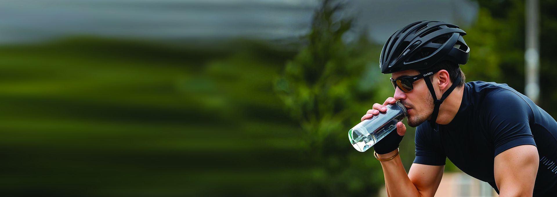 A cyclist drinking from a WaterHero bottle